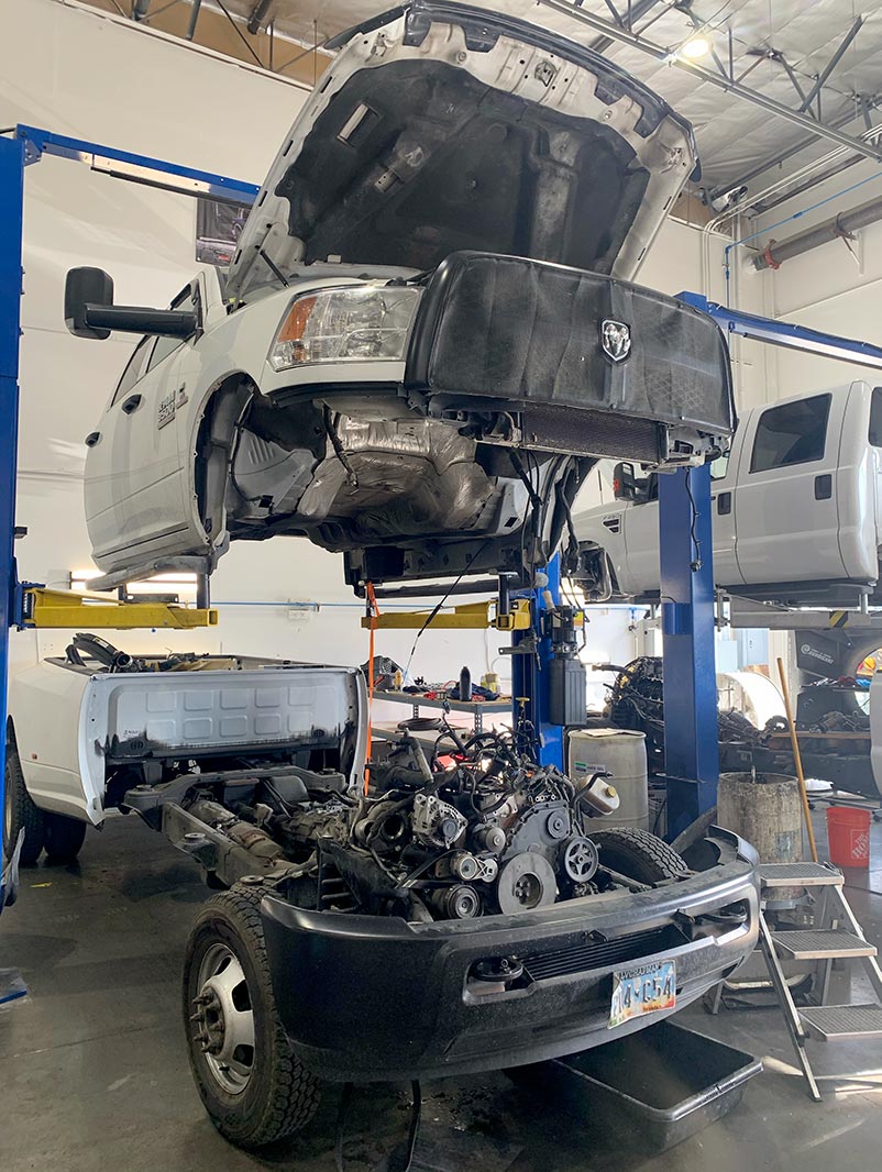 A truck lifted and opened up for diesel repair